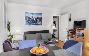 a living room with a table with a bowl of fruit on it at Stunning Apartment In København Sv in Copenhagen