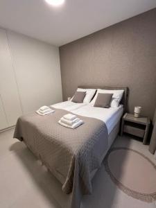 a bedroom with a bed with two towels on it at TM APARTMENTS Ludwiki in Warsaw