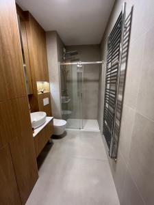 a bathroom with a shower and a toilet and a sink at TM APARTMENTS Ludwiki in Warsaw +38 photos