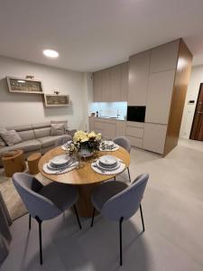 a living room with a wooden table and chairs at TM APARTMENTS Ludwiki in Warsaw