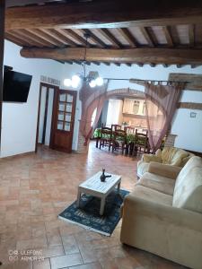 a living room with a couch and a table at Villa Nobile Cortona in Cortona