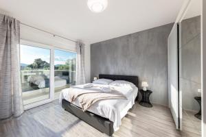 a bedroom with a large bed and a large window at Villa Gabriel - Dicmo in Dicmo +50 photos