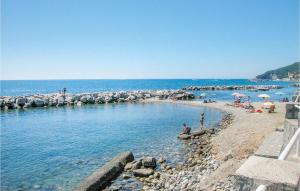 a group of people sitting on a beach in the water at Villa Sole in Bosco