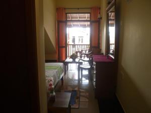 a room with a bed and a table and a balcony at Southern Villa in Bentota +20 photos