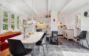 a kitchen and dining room with a table and chairs at 2 Bedroom Cozy Home In Allinge in Allinge