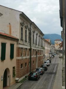 a city street with cars parked next to buildings at Open Space in Bassano del Grappa