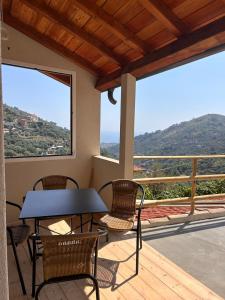 a table and chairs on a balcony with a view at Casa Matilde in Sanremo +15 photos