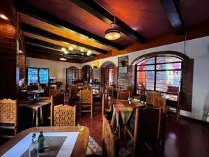 a dining room with tables and chairs in a restaurant at Hotel Boutique Posada la Casona de Cortés in Tlaxcala de Xicohténcatl