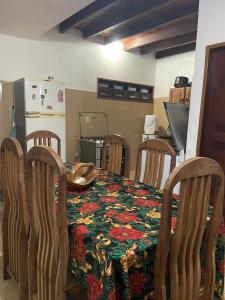 a kitchen with a table and chairs with a table and a table at casa ilha de itamaraca in Itamaracá