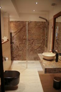 a bathroom with a shower and a sink and a tub at Apartament Erica in Zakopane +45 photos
