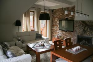 a living room with a couch and a table at Apartament Erica in Zakopane