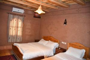 Postel nebo postele na pokoji v ubytování Gîte d'étape Tamaloute
