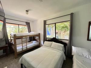 a bedroom with a bed and two windows at Hotel Boutique Casa Berastegui in Puerto Colombia +119 photos
