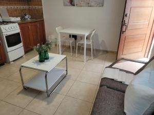 a living room with a table and a kitchen at small apartment in Santo Domingo +1 photo