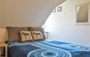 a bedroom with a bed with two pillows on it at 2 Bedroom Lovely Apartment In Lemvig in Lemvig +9 photos