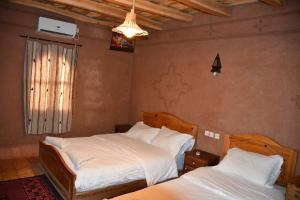 Postel nebo postele na pokoji v ubytování Gîte d'étape Tamaloute