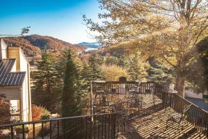 a balcony of a house with chairs and trees at Mountain Loft Resort - Lake Lure, NC in Lake Lure +16 photos