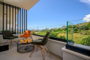 a balcony with two chairs and a table with fruit on it at Luxury Apartment Cocco - Split in Split