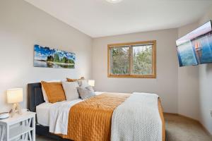 una camera da letto bianca con un letto e una finestra di Cherry Hill - Minutes to Downtown! Hot Tub, Spacious Yard & Dogs OK! a Sister Bay