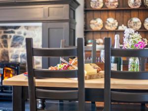 a table with a plate of food on top of it at Flossy's House -Uk35020 in Chatton