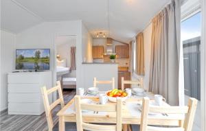a dining room and kitchen with a table and chairs at Chalet 21 Am See in Süsel