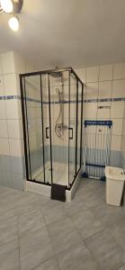 a shower stall in a room with a toilet at Apartament Rabinówka in Maruszyna +38 photos