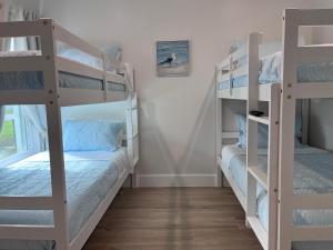 a room with two bunk beds and a window at Near Sports Complex OWA beaches shopping restaurants mini golf Central to all the fun Foley has to offer in Foley