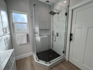 a shower with a glass door in a bathroom at Near Sports Complex OWA beaches shopping restaurants mini golf Central to all the fun Foley has to offer in Foley +32 photos