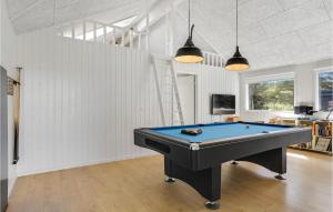 a pool table in the middle of a room at Lovely Home In Blokhus With Sauna in Blokhus