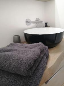 a bathroom with a sink and a towel on a counter at En pleine verdure in Glaignes +11 photos