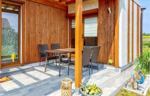 a wooden deck with a table and chairs on it at Nice Home In Kladno With Wifi in Pleśna