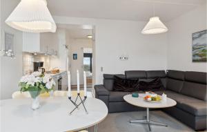 a living room with a couch and a table at Fanø Bad, Lejl 74 in Fanø