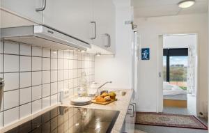 a kitchen with a counter top with a sink at Fanø Bad, Lejl 74 in Fanø