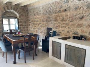 a kitchen with a wooden table and a stove at 19th Century Mansion in Arachova +16 photos