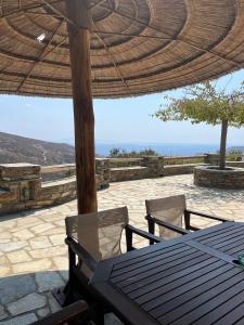 a table and chairs under an umbrella on a patio at Anastasia Luxury Villas in Gavrio