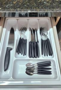 a plastic container filled with utensils in a drawer at Ap Ubatuba in Ubatuba +18 photos