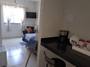 a room with a kitchen and a living room at MAHALO 1004 Suites in Maricá