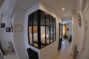 a hallway with a large window on the wall at Le Yellow Corner Voironnais in Voiron
