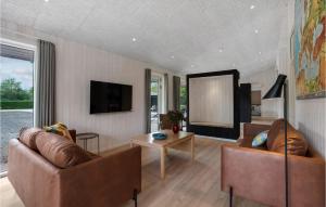 a living room with two couches and a table at Gorgeous Home In Oksbøl With Sauna in Oksbøl