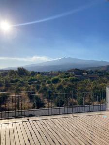 a view of the mountains from a deck at Villetta Alcantara Apartment in Calatabiano