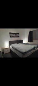 a bedroom with a bed and a night stand at Landgasthaus Birkegg Familienzimmer in Leutasch