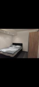 a bedroom with two beds and a wooden cabinet at Landgasthaus Birkegg Familienzimmer in Leutasch