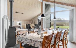 a dining room with a table and chairs at Holiday Home Tarm 49 in Hemmet