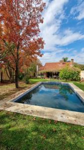 a swimming pool in the yard of a house at Casa Calandria in Federación