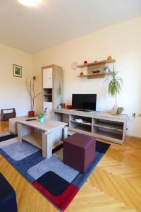 a living room with a coffee table and a tv at Apartment Skopje Square in Skopje