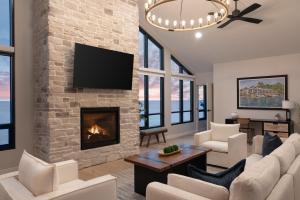 a living room with a fireplace and a tv at The Wave at Marblehead in Marblehead