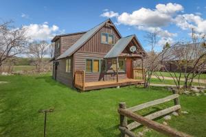 a small house with a porch and a fence at Hiker in Clark