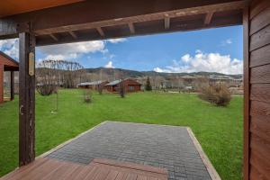 a screened in porch with a view of a yard at Homesteader in Clark