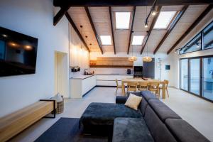 a living room with a couch and a table and a kitchen at Cabana Rapsodia in Dejani