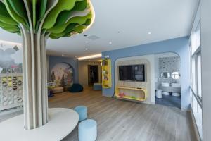 a room with a tree in the middle of it at Le Parc Residence Deluxe Suite in Quito
